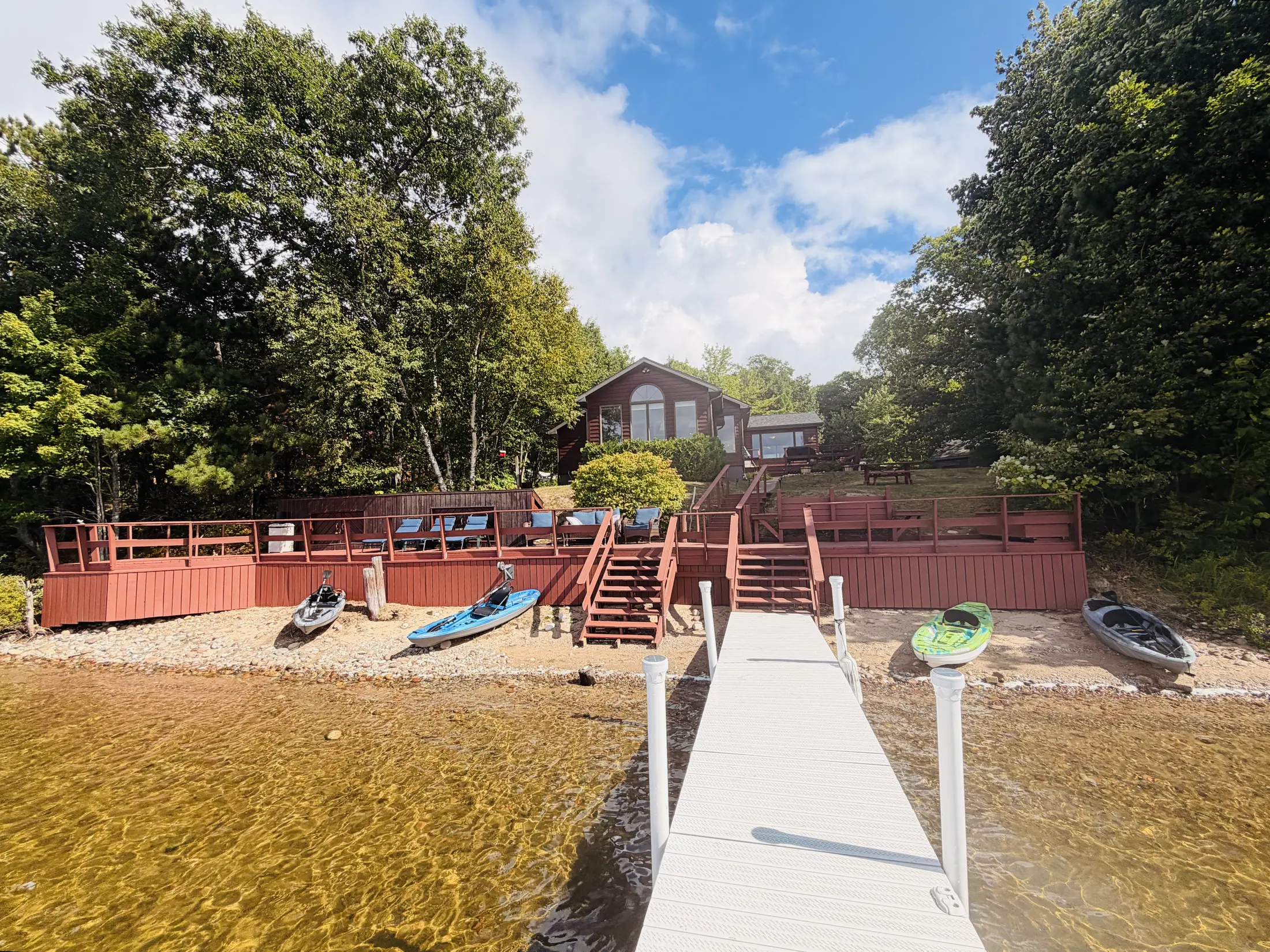 Private dock, shoreline and guest kayaks at The Loon Hollow