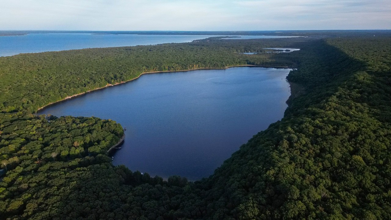 Aerial view of Monocle Lake surrounded by forest