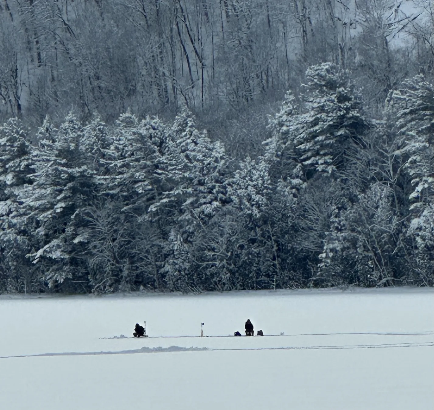 Ice fishing on a snow-covered lake
