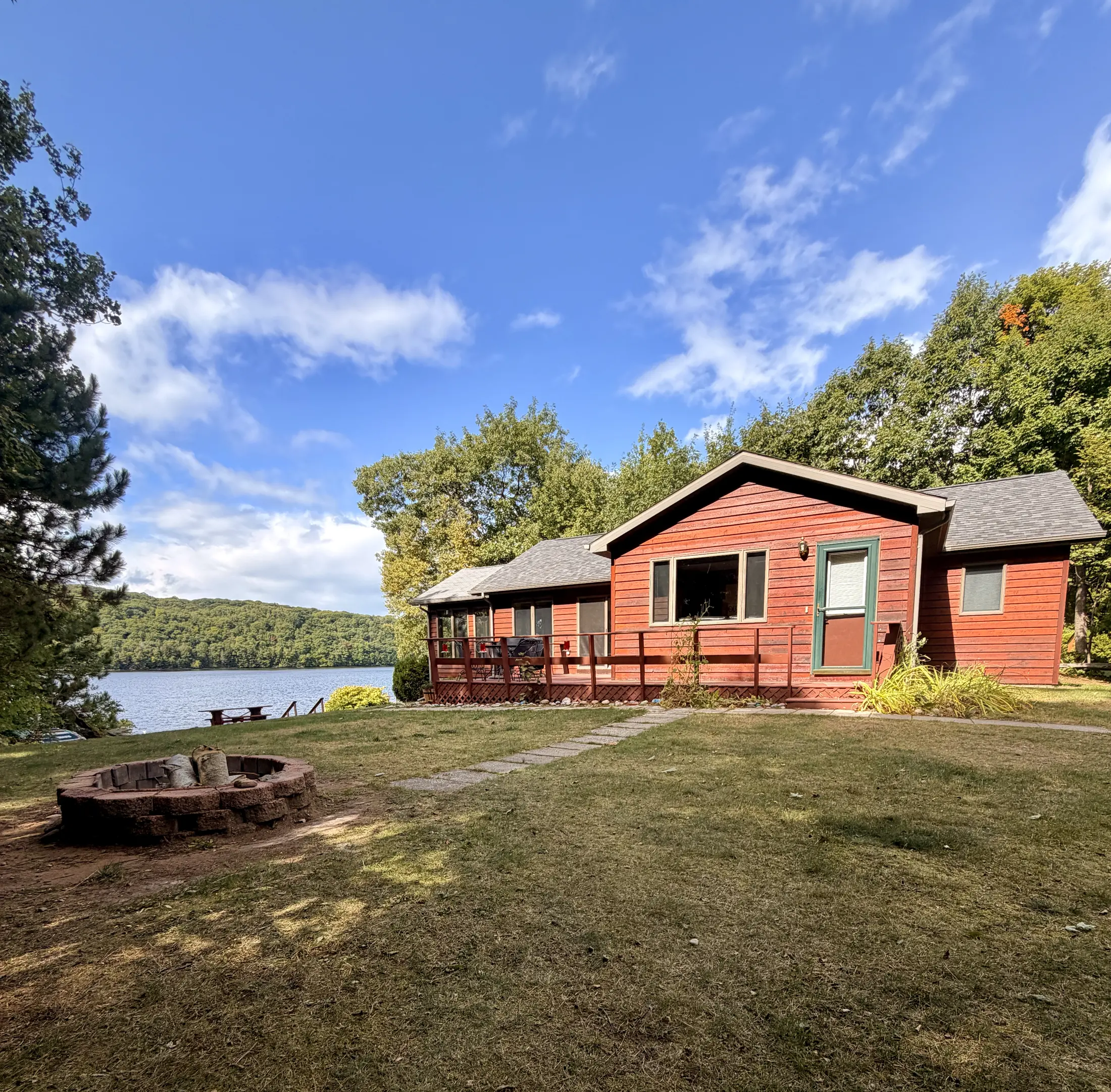 Fire pit and lawn leading toward Monocle Lake
